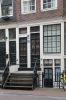 Houten onderpui met twee ingangen en een frontale houten stoep Houten onderpui met twee ingangen en een frontale houten stoep (© Walther Schoonenberg)